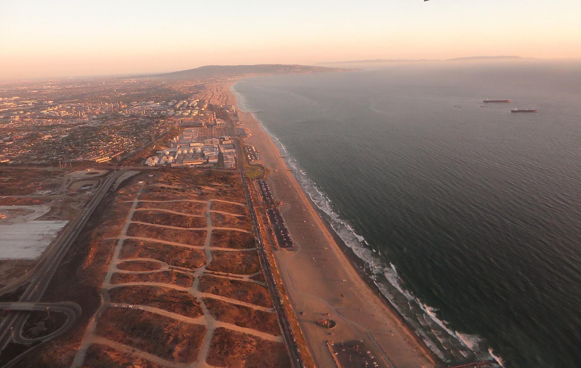 Golden-hour aerial of the El Segundo coastline in the South Bay